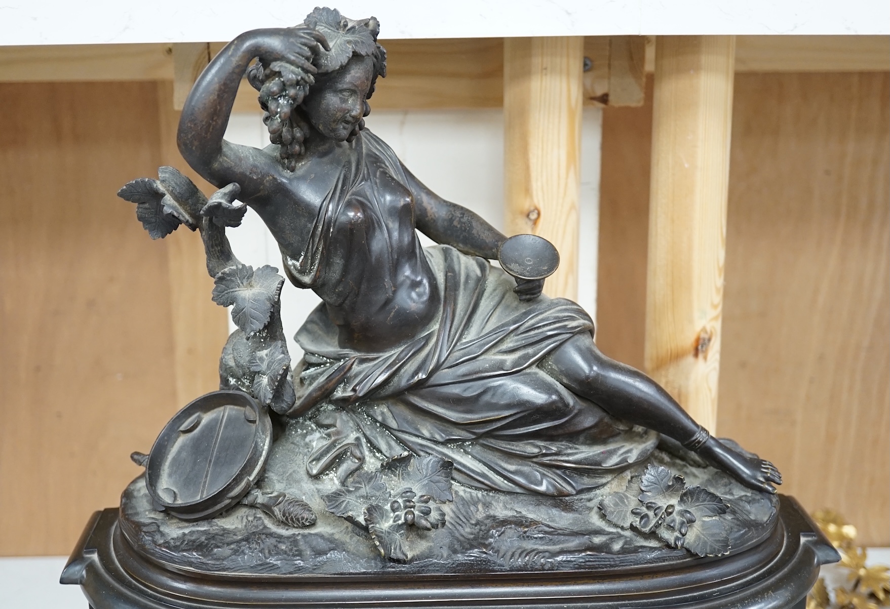 A Victorian black marble eight day mantel clock, surmounted by a cast bronze figure of a muse, with key, 48cm high. Condition - fair, untested